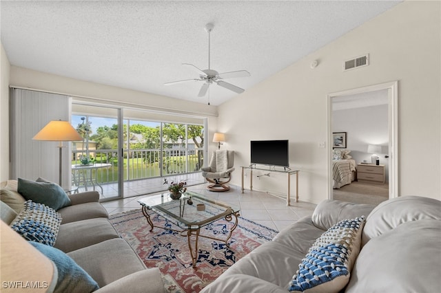 1190 Yesica Ann Cir Unit B205, Naples, FL 34110 - tiled living area featuring a textured ceiling, ceiling fan, and vaulted ceiling
