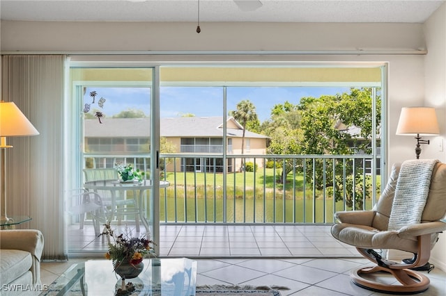 1190 Yesica Ann Cir Unit B205, Naples, FL 34110 - tiled living room featuring a ceiling fan