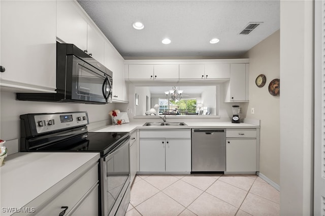 1190 Yesica Ann Cir Unit B205, Naples, FL 34110 - kitchen featuring stainless steel appliances, light countertops, white cabinets, recessed lighting, and light tile patterned floors