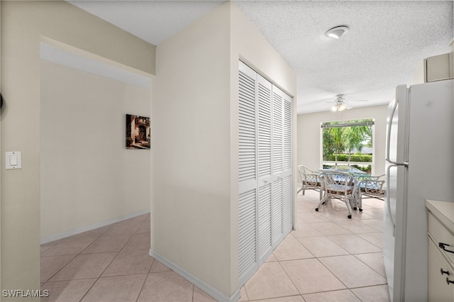 1190 Yesica Ann Cir Unit B205, Naples, FL 34110 - corridor with light tile patterned flooring and a textured ceiling