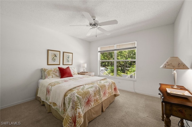 1190 Yesica Ann Cir Unit B205, Naples, FL 34110 - bedroom featuring carpet, a textured ceiling, and ceiling fan