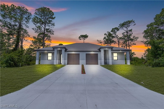452/454 Loretta Ave S, Lehigh Acres, FL 33974 - prairie-style home featuring an attached garage, a front yard, concrete driveway, and stucco siding