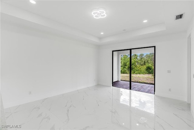 452/454 Loretta Ave S, Lehigh Acres, FL 33974 - unfurnished room featuring light marble finish flooring, a raised ceiling, recessed lighting, and baseboards