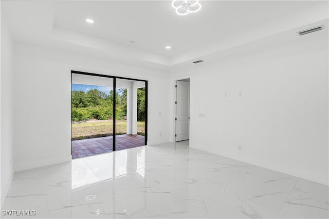 452/454 Loretta Ave S, Lehigh Acres, FL 33974 - empty room featuring light marble finish flooring, a raised ceiling, baseboards, and recessed lighting