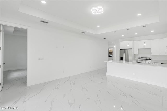 452/454 Loretta Ave S, Lehigh Acres, FL 33974 - unfurnished living room featuring a raised ceiling, recessed lighting, baseboards, and light marble finish floors