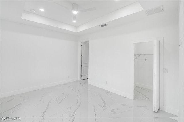 452/454 Loretta Ave S, Lehigh Acres, FL 33974 - unfurnished bedroom featuring light marble finish floors, baseboards, recessed lighting, a tray ceiling, and a closet