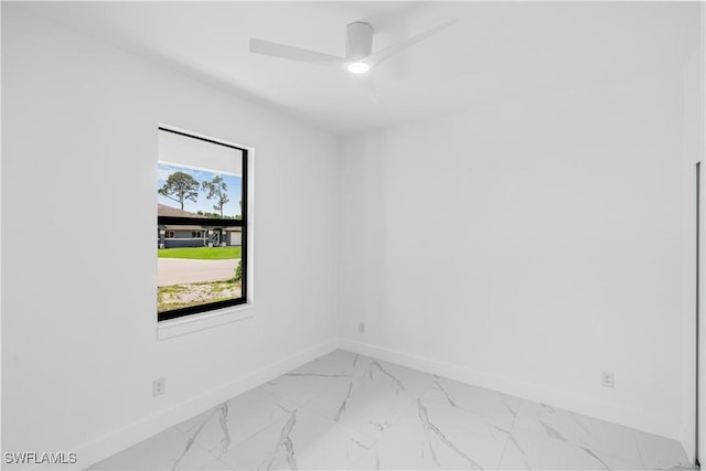 452/454 Loretta Ave S, Lehigh Acres, FL 33974 - unfurnished room with baseboards, light marble finish flooring, and ceiling fan