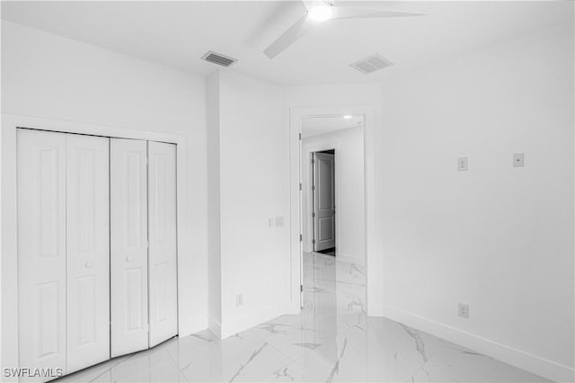 452/454 Loretta Ave S, Lehigh Acres, FL 33974 - unfurnished bedroom featuring baseboards, light marble finish floors, a closet, and ceiling fan