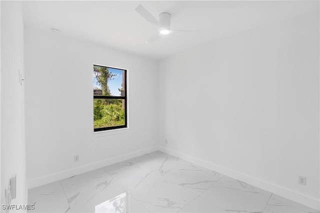 452/454 Loretta Ave S, Lehigh Acres, FL 33974 - empty room featuring baseboards, light marble finish flooring, a ceiling fan, and a smoke detector