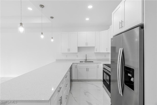 452/454 Loretta Ave S, Lehigh Acres, FL 33974 - kitchen with stainless steel appliances, recessed lighting, a sink, a peninsula, and light marble finish flooring