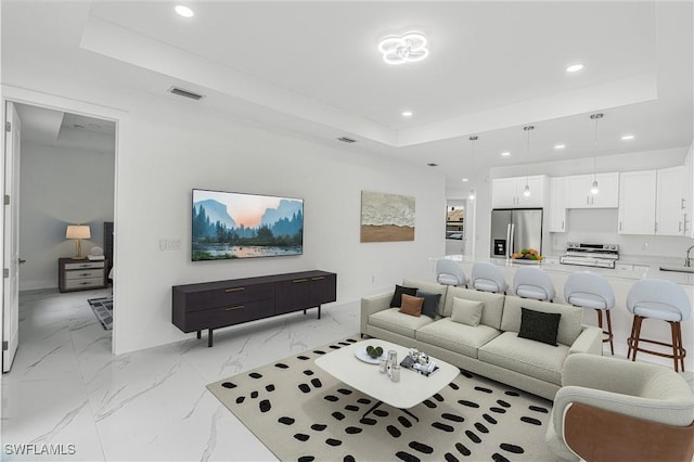 452/454 Loretta Ave S, Lehigh Acres, FL 33974 - living area featuring a raised ceiling, recessed lighting, light marble finish floors, and baseboards