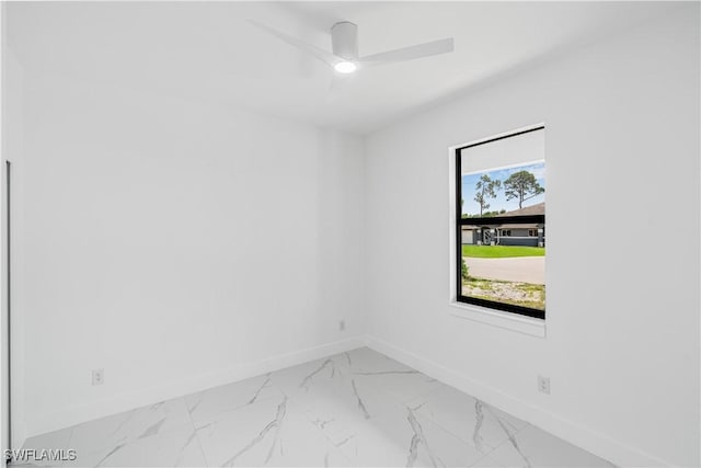 452/454 Loretta Ave S, Lehigh Acres, FL 33974 - spare room with baseboards, marble finish flooring, and a ceiling fan