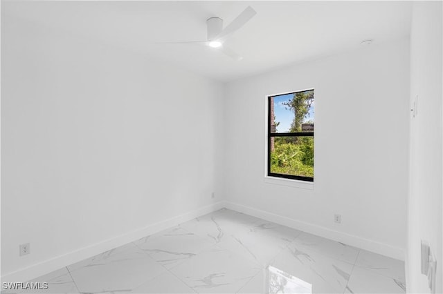452/454 Loretta Ave S, Lehigh Acres, FL 33974 - empty room featuring baseboards, light marble finish floors, and a ceiling fan