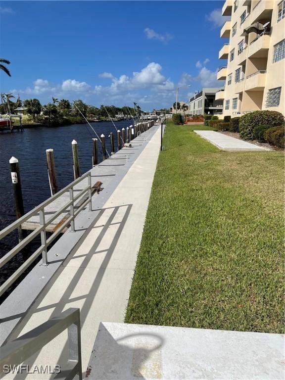 1766 Cape Coral Pkwy E Unit 410, Cape Coral, FL 33904 - dock featuring a lawn and a water view