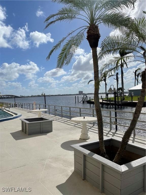 1766 Cape Coral Pkwy E Unit 410, Cape Coral, FL 33904 - view of patio with a water view and a dock