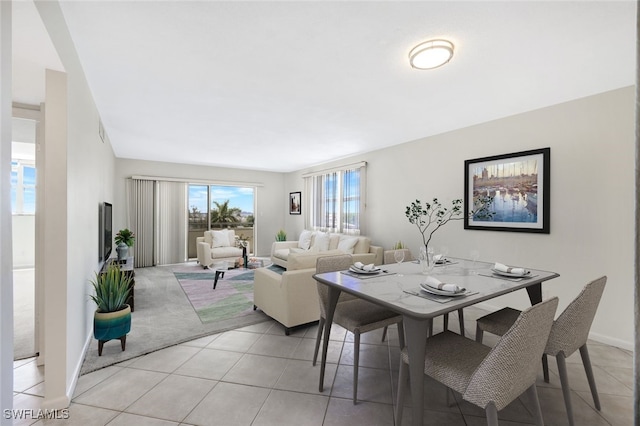 1766 Cape Coral Pkwy E Unit 410, Cape Coral, FL 33904 - dining space featuring light tile patterned floors, baseboards, and light colored carpet