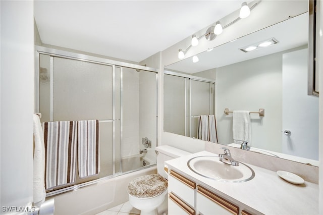 1766 Cape Coral Pkwy E Unit 410, Cape Coral, FL 33904 - bathroom featuring toilet, vanity, combined bath / shower with glass door, and tile patterned flooring