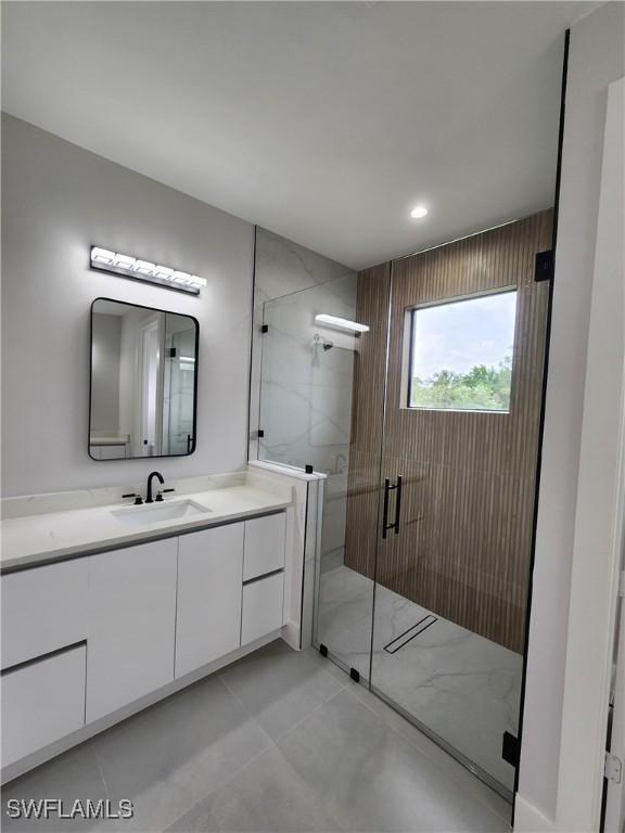 3279 31st Ave NE, Naples, FL 34120 - bathroom featuring vanity, a shower stall, and recessed lighting