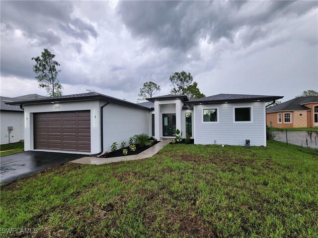 3279 31st Ave NE, Naples, FL 34120 - view of front of property with an attached garage and asphalt driveway