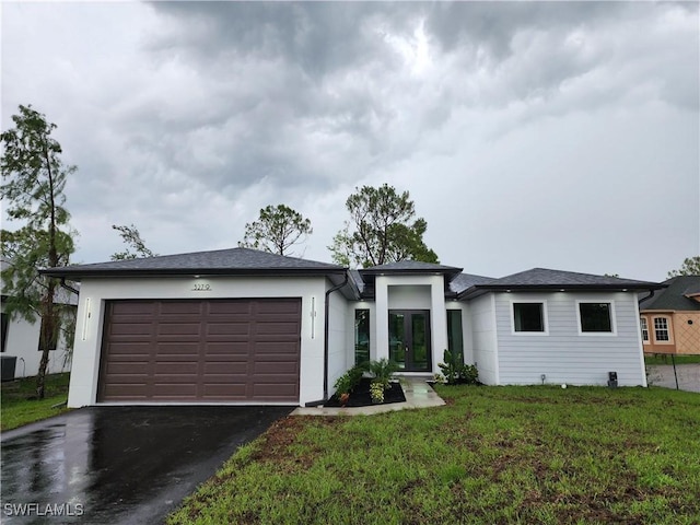 3279 31st Ave NE, Naples, FL 34120 - prairie-style home featuring a garage, asphalt driveway, a front yard, french doors, and stucco siding