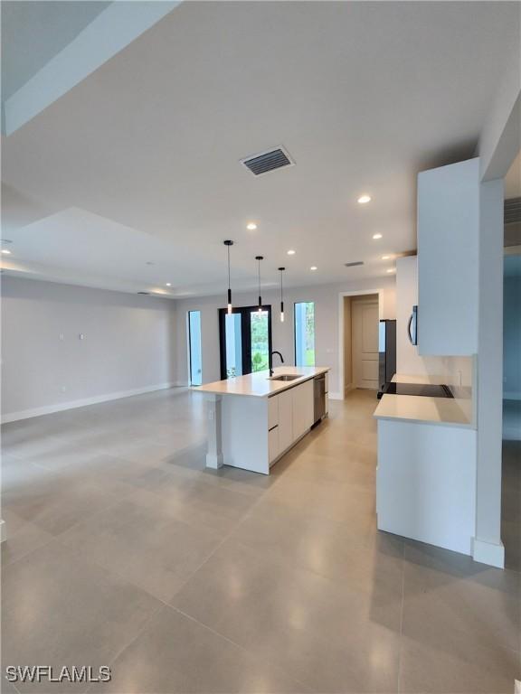 3279 31st Ave NE, Naples, FL 34120 - kitchen featuring appliances with stainless steel finishes, light countertops, recessed lighting, white cabinets, and pendant lighting