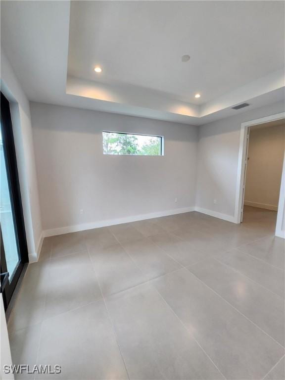 3279 31st Ave NE, Naples, FL 34120 - unfurnished room with a raised ceiling, recessed lighting, baseboards, and light tile patterned flooring