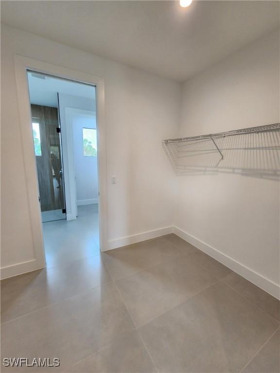 3279 31st Ave NE, Naples, FL 34120 - walk in closet featuring tile patterned flooring