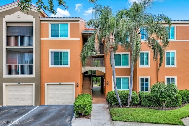 1220 Reserve Way Unit 107, Naples, FL 34105 - view of property with driveway and a garage