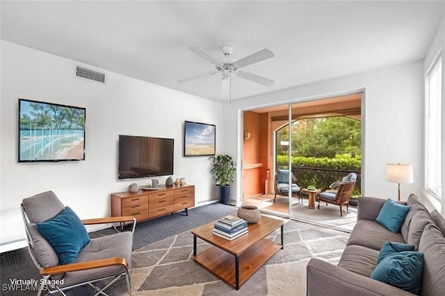 1220 Reserve Way Unit 107, Naples, FL 34105 - carpeted living area featuring healthy amount of natural light and ceiling fan