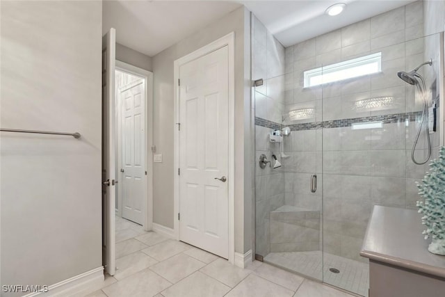 14559 Topsail Dr, Naples, FL 34114 - bathroom featuring a stall shower, baseboards, and tile patterned flooring