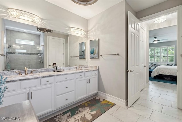 14559 Topsail Dr, Naples, FL 34114 - ensuite bathroom featuring double vanity, a shower stall, baseboards, tile patterned flooring, and ceiling fan