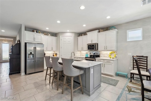 14559 Topsail Dr, Naples, FL 34114 - kitchen with stainless steel appliances, a sink, decorative backsplash, plenty of natural light, and recessed lighting