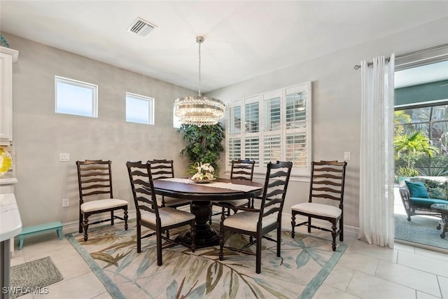 14559 Topsail Dr, Naples, FL 34114 - dining space featuring light tile patterned floors and a chandelier
