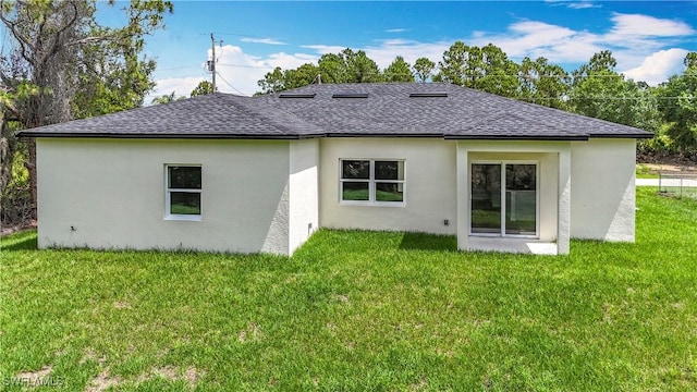 Anthony Anthony Street E 912, Lehigh Acres, FL 33974 - rear view of house with roof with shingles, stucco siding, and a lawn