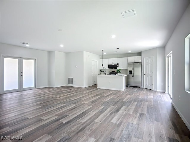 Anthony Anthony Street E 912, Lehigh Acres, FL 33974 - unfurnished living room with wood finished floors, recessed lighting, plenty of natural light, and french doors