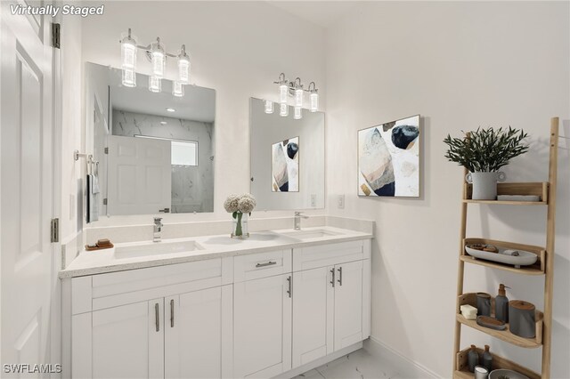 2807 19th St W, Lehigh Acres, FL 33971 - full bath with double vanity, a marble finish shower, marble look tile flooring, and baseboards