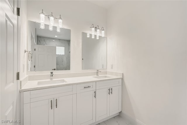 2807 19th St W, Lehigh Acres, FL 33971 - full bathroom with double vanity, marble look tile flooring, a marble finish shower, and baseboards