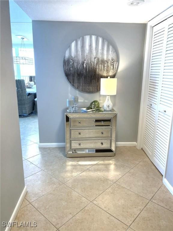 7150 Estero Blvd Unit 800, Fort Myers Beach, FL 33931 - hallway featuring baseboards and light tile patterned floors