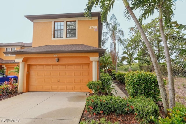 3799 Costa Maya Way Unit 202, Estero, FL 33928 - view of front of property featuring stucco siding, an attached garage, and concrete driveway