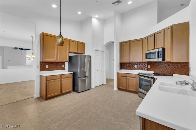 3799 Costa Maya Way Unit 202, Estero, FL 33928 - kitchen with appliances with stainless steel finishes, a sink, arched walkways, light countertops, and recessed lighting