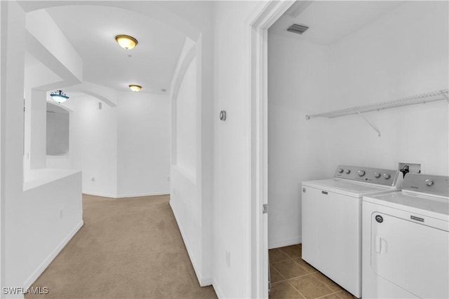 3799 Costa Maya Way Unit 202, Estero, FL 33928 - laundry room with separate washer and dryer, arched walkways, light carpet, and baseboards