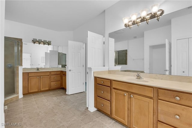 3799 Costa Maya Way Unit 202, Estero, FL 33928 - bathroom featuring two vanities, a shower stall, and vaulted ceiling