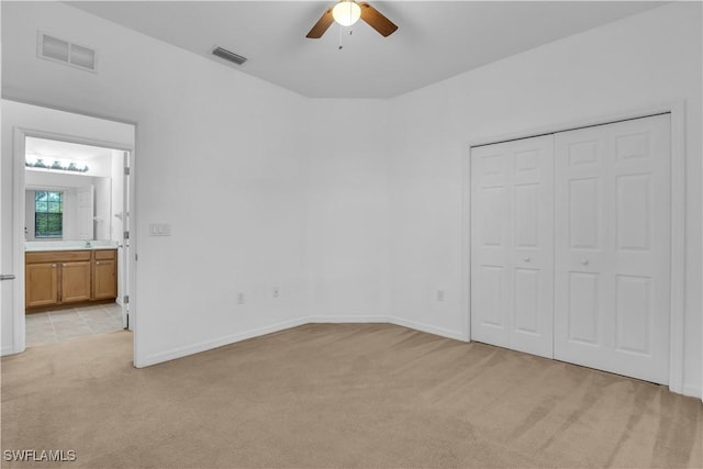 3799 Costa Maya Way Unit 202, Estero, FL 33928 - unfurnished bedroom featuring light colored carpet, a closet, and baseboards