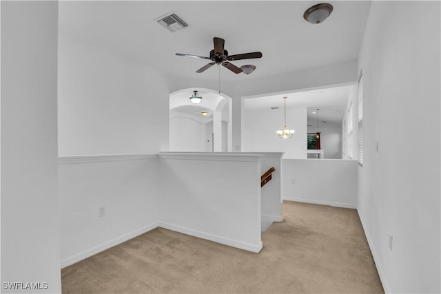 3799 Costa Maya Way Unit 202, Estero, FL 33928 - empty room featuring light carpet, ceiling fan, baseboards, and a chandelier