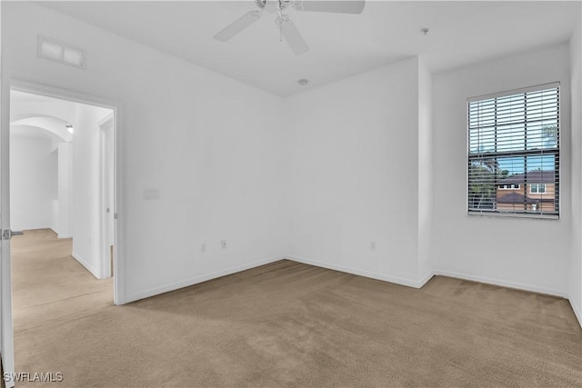 3799 Costa Maya Way Unit 202, Estero, FL 33928 - unfurnished room featuring light carpet, arched walkways, ceiling fan, and baseboards