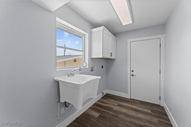3061 Shell Mound Blvd, Fort Myers Beach, FL 33931 - laundry room with electric dryer hookup, cabinet space, baseboards, and dark wood finished floors