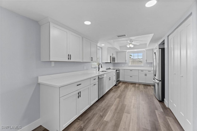 3061 Shell Mound Blvd, Fort Myers Beach, FL 33931 - kitchen with stainless steel appliances, a sink, a ceiling fan, wood finished floors, and recessed lighting