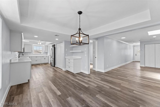 3061 Shell Mound Blvd, Fort Myers Beach, FL 33931 - unfurnished living room featuring a sink, baseboards, a raised ceiling, dark wood-style flooring, and recessed lighting