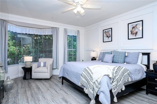 133 Colonade Cir, Naples, FL 34103 - bedroom featuring light wood-style flooring, ornamental molding, a ceiling fan, a decorative wall, and baseboards