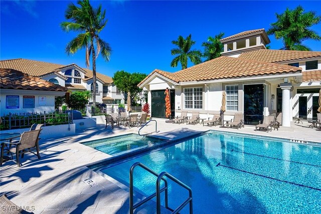133 Colonade Cir, Naples, FL 34103 - community pool featuring a community hot tub, a patio, and a residential view